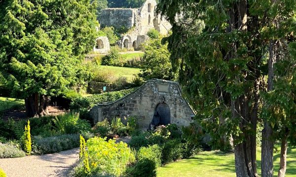 Jervaulx Hall gardens with Abbey in background